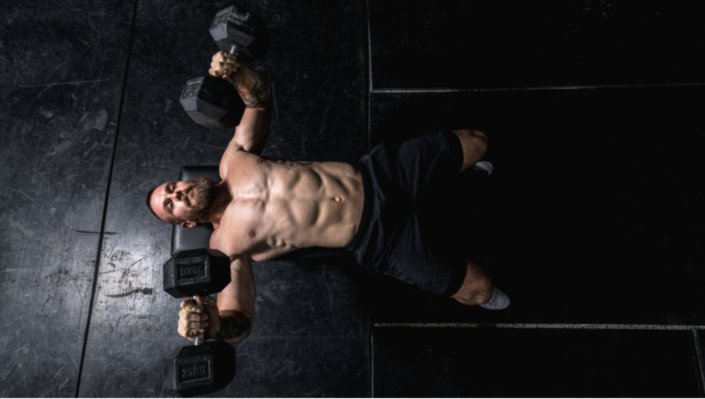 a man doing dumbbell bench press 