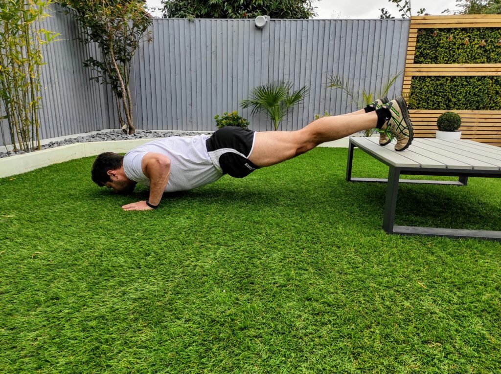 a man doing decline push ups 