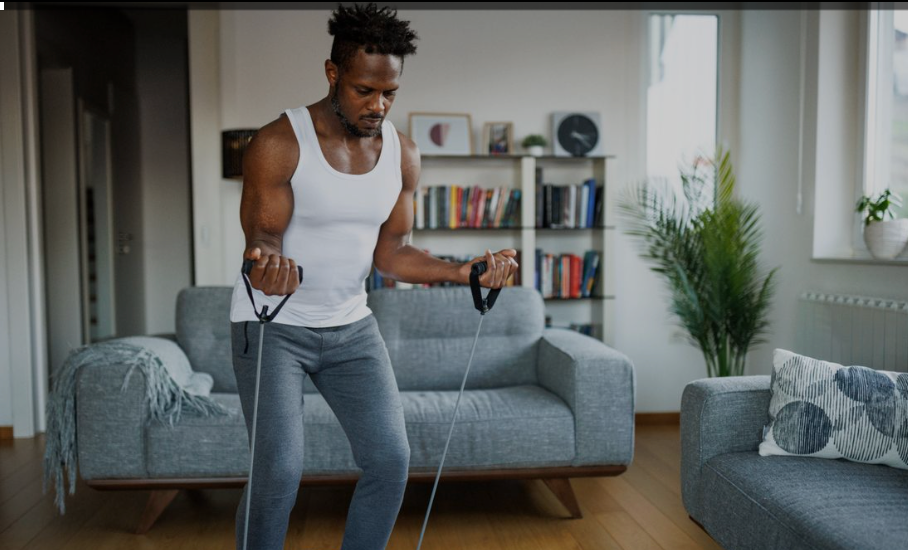 a man doing biceps curls with  Resistance Bands