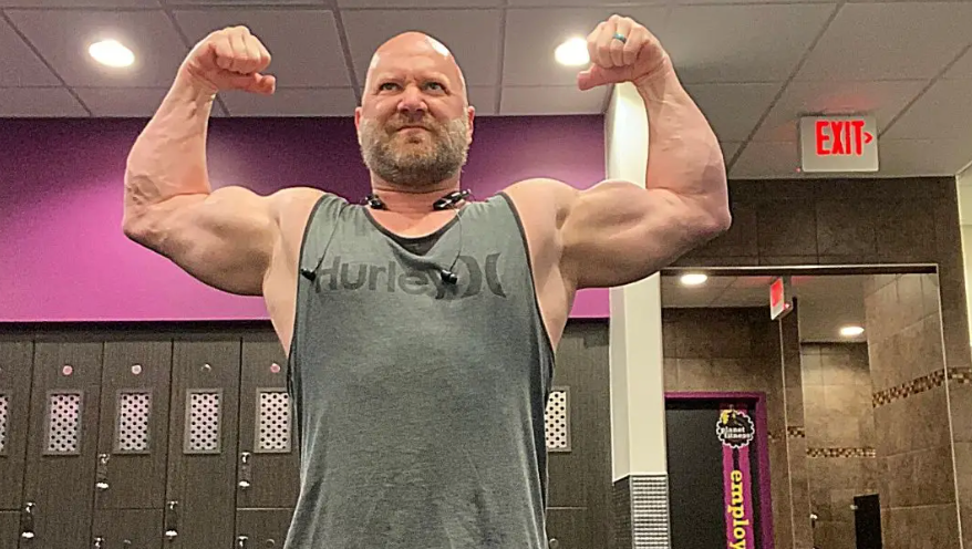 a man over 40 flexing double biceps 