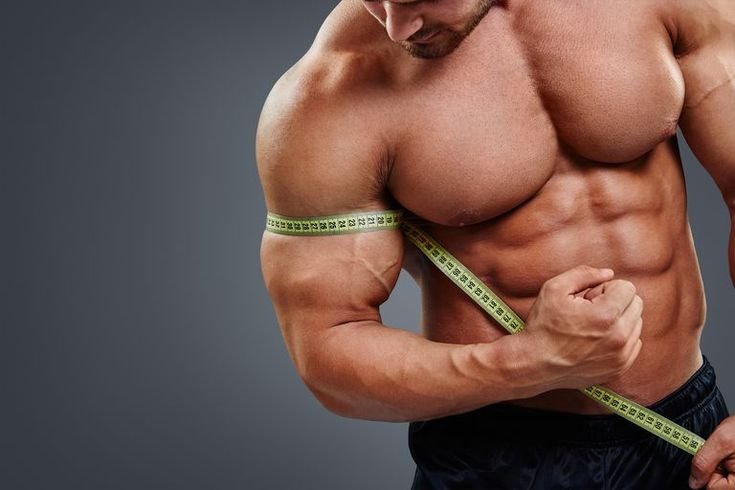 a man measuring his biceps 